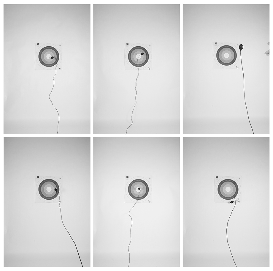 Six black and white images of a target on a wall by Jordan Ridout.