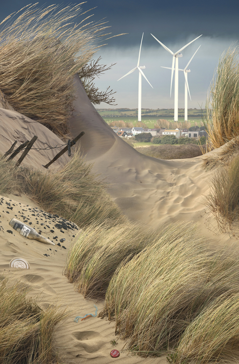 A view through the sand dunes of wind turbines. Picture by Emily Allchurch, currently on display at Lucy Bell Gallery